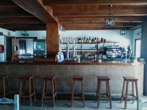 a bar with wooden stools in a restaurant at La Aceitera de Trafalgar in Zahora