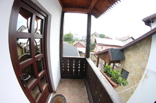 a balcony with a wooden door and a view at Casa Bucovineana in Suceava