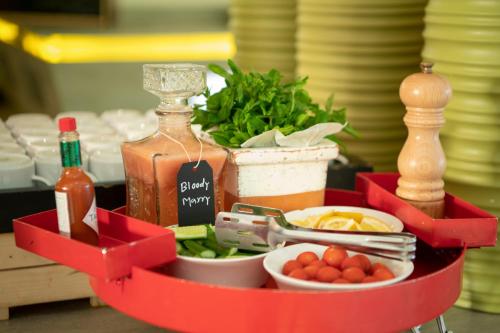 a tray of food with a bottle of alcohol and vegetables at Radisson Blu Resort Jizan in Jazan