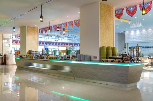 a restaurant with a bar in a large room at Radisson Blu Resort Jizan in Jazan