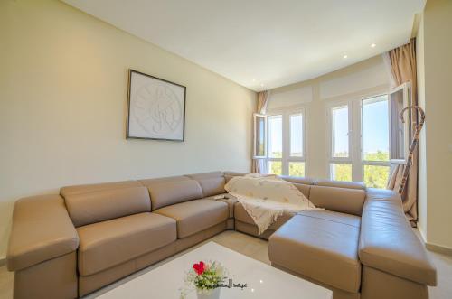 a living room with a brown leather couch at Mnar Park aqua park in Tangier
