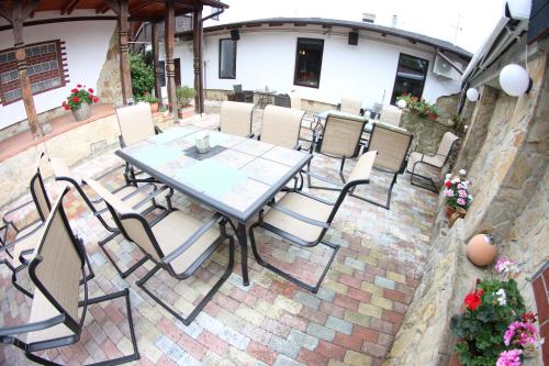 a table and chairs on a brick patio at Casa Bucovineana in Suceava