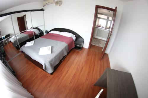 a bedroom with a bed and a mirror at Casa Bucovineana in Suceava