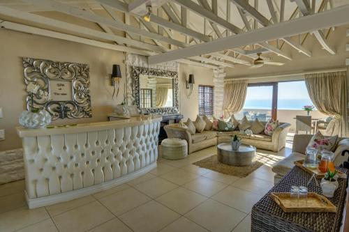 a living room with a couch and a table at The View Boutique Hotel & Spa in Amanzimtoti