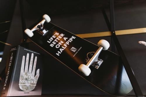 a book and a fork and spoon on a table at Hotel ZOE by AMANO in Berlin