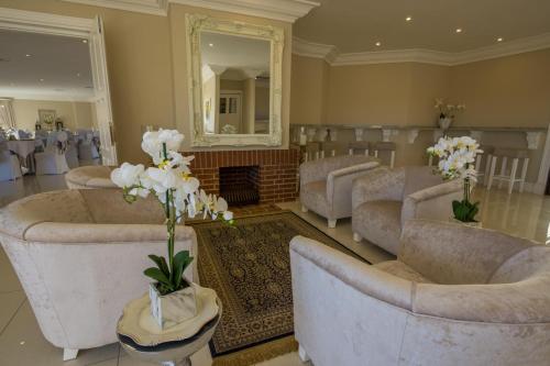a large living room with couches and a fireplace at The View Boutique Hotel & Spa in Amanzimtoti