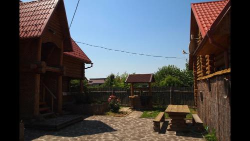 a patio with a picnic table and a fence at "У вуйка" in Uzhhorod