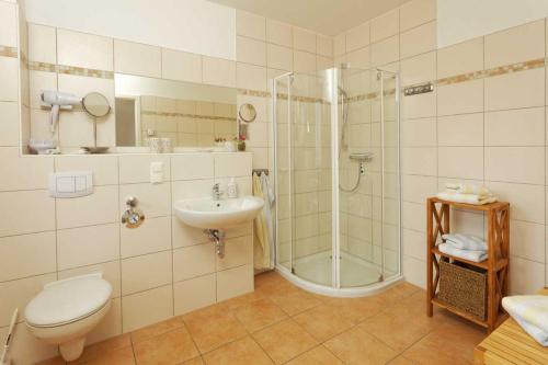 a bathroom with a shower and a toilet and a sink at Zempin Ostseepark WE 36 _Insel Use in Zempin