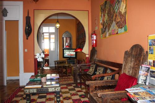 a living room filled with furniture and a fire place at Porto Riad - Guest House in Porto