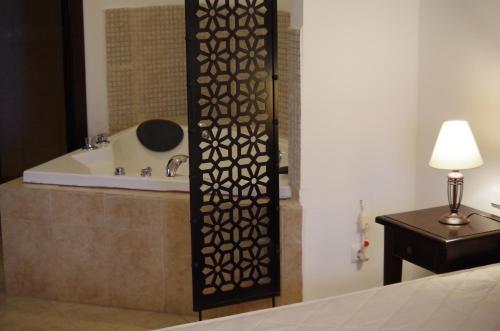 a bathroom with a bath tub and a shower with a table at Beautiful 1st-Line Seaview Private Appartement in The Cliff resort in Obzor