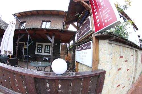 a building with a fence and a table in front of it at Casa Bucovineana in Suceava