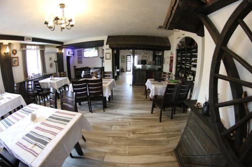 a dining room with tables and chairs in a restaurant at Casa Bucovineana in Suceava