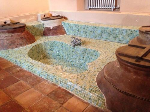 a tile floor with a fountain in the middle of a room at Hotel Cortijo del Marqués in Albolote
