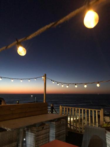 a patio with a view of the ocean at night at The Spa Hotel in Saltburn-by-the-Sea