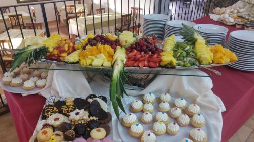 a table topped with two trays of fruit and pastries at La Fattoria in Castelsardo