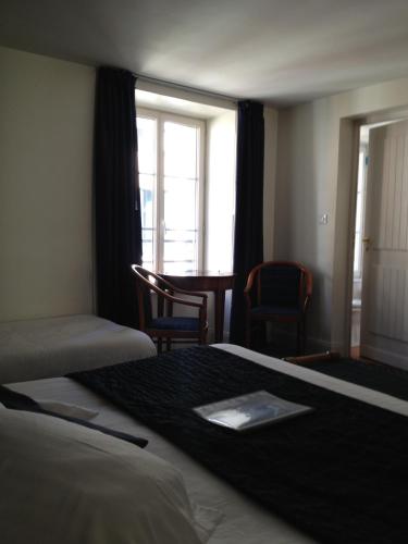 Ein Bett oder Betten in einem Zimmer der Unterkunft Le Querrien