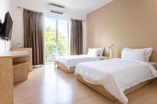 O2 Hotel Lopburi tesisinde bir odada yatak veya yataklar