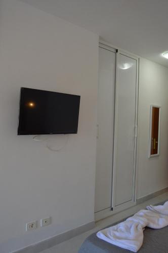 a bedroom with a flat screen tv on the wall at Apartamento Tobago in Puerto Rico de Gran Canaria