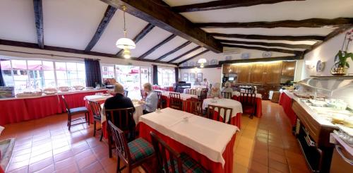 a restaurant with tables, chairs, and tables in it at Quinta Da Penha De Franca in Funchal