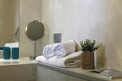 a bathroom with towels on a counter with a mirror at Hotel Logotel in Eisenach