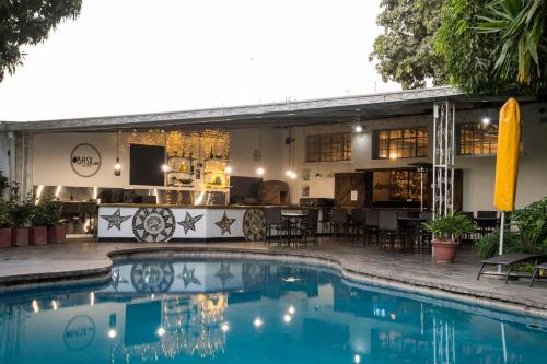 a house with a swimming pool in front of it at Fawlty Towers Accommodation & Activities in Livingstone