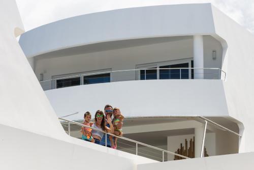 a group of people standing on the balcony of a cruise ship at Puerto Plaza Las Terrenas in Las Terrenas