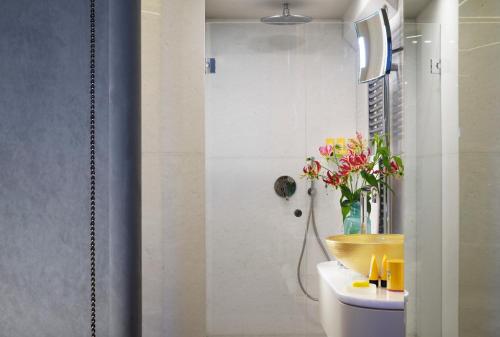 a bathroom with a sink, toilet, and mirror at San Firenze Suites & Spa in Florence