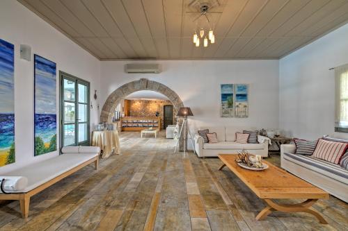 a living room with white furniture and a table at Dioni Hotel in Skiros