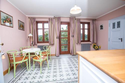 a kitchen and dining room with a table and chairs at Penzion Šatlava in Nové Město nad Metují