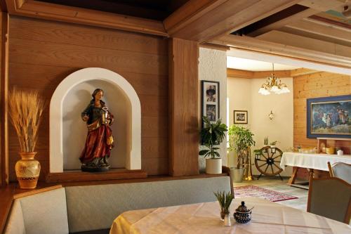 a statue of a woman on a table in a room at Hotel & Suites Glück Auf in Mayrhofen