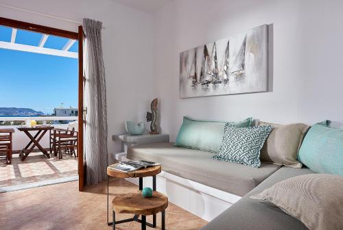 a living room with a couch and a table at Mirabeli Apartments & Suites in Pollonia