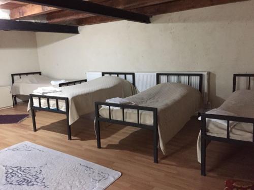 a room with three beds in a room at Lazuri Keria Family Guesthouse in Khoni