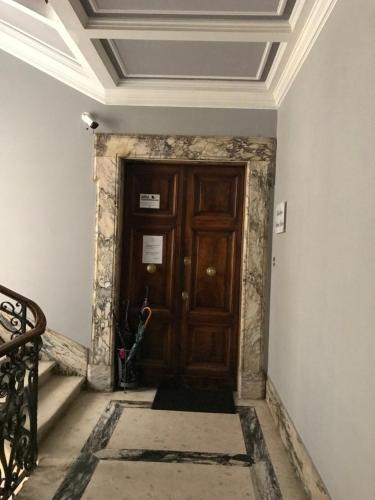 a hallway with a wooden door in a building at Residenza Vatican Suite in Rome