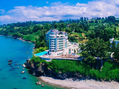 an aerial view of a building on a hill next to the water at Castello Mare Hotel in K'obulet'i