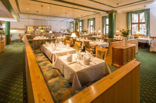 a restaurant with tables and chairs in it at Stadthotel Freiburg Kolping Hotels & Resorts in Freiburg im Breisgau