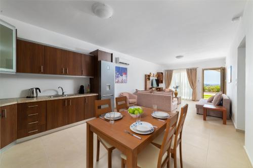a kitchen and living room with a table and chairs at Kolymbia Village in Kolimbia