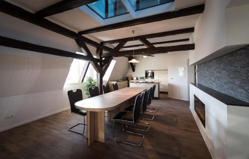 a dining room with a table and a fireplace at Buri Island in Hoyerswerda