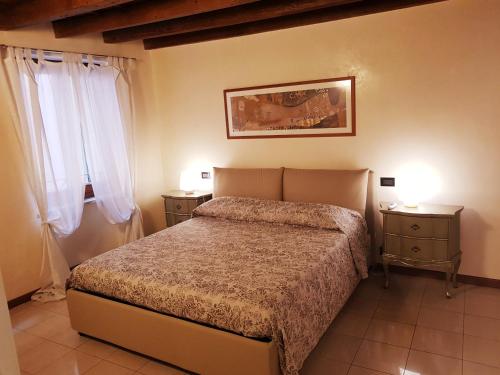 a bedroom with a bed and two night stands at Elly's House in Verona