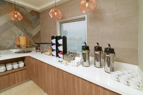 a kitchen with a counter with a bunch of appliances at Wyndham Garden Monterrey Valle Real in Monterrey