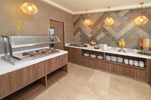 a restaurant kitchen with a buffet line with food at Wyndham Garden Monterrey Valle Real in Monterrey