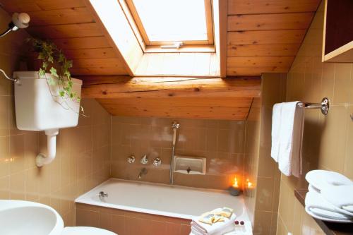 a bathroom with a bath tub and a window at Chalet dell'Ermellino in Bormio