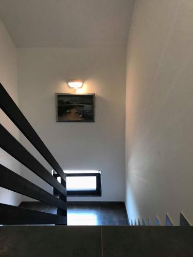 a staircase in a building with a picture on the wall at Filipovic rent a car & apartments in Selnica Šćitarjevska