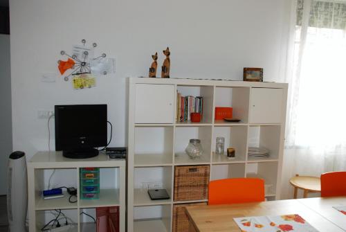 a white book shelf with a television on it at Casa dolce casa in Viareggio