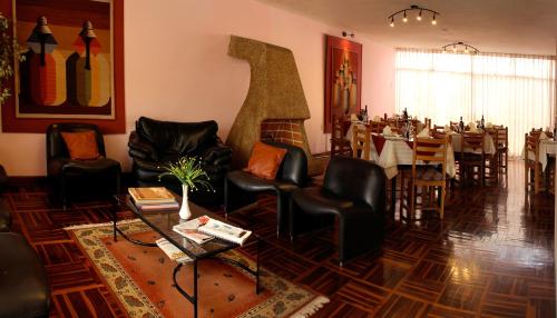 a restaurant with tables and chairs and a dining room at Los Q'eros in Lima