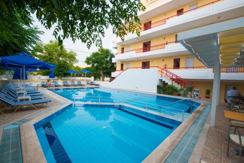 a large swimming pool in front of a hotel at Erato Studios & Apartments in Kos Town