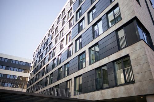 a building with glass windows on the side of it at the niu Cobbles in Essen