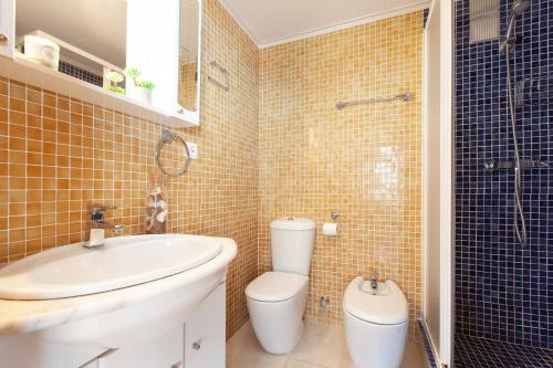 a bathroom with a toilet and a sink and a shower at Lets Holidays Apartment Costa Brava in Tossa de Mar