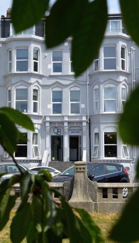 a white building with cars parked in front of it at Q8 Boutique Hotel in Portsmouth