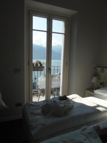 a bedroom with a bed and a view of the ocean at Albergo Dongo in Dongo