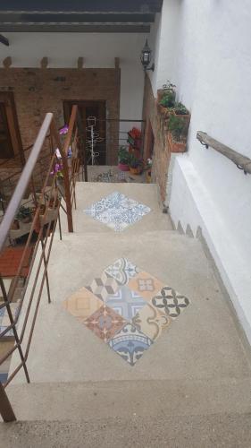 a patio with mosaics on the floor of a building at Casa Ensueño Hogar Boutique in Guaduas